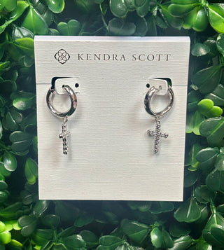 Silver cross crystal huggie hoop earrings with white crystal cross charm.