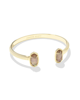 Style | Dainty pinch cuff with signature oval stone stations

Metal | 14k yellow gold over brass

Stone | Taupe mother-of-pearl

Fit | Adjustable cuff

Size | 2.28-inch inner diameter; 0.67-inch L x 0.38-inch W station