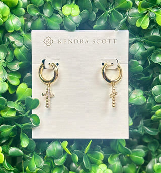 Gold cross crystal huggie hoop earrings with white crystal cross charm.