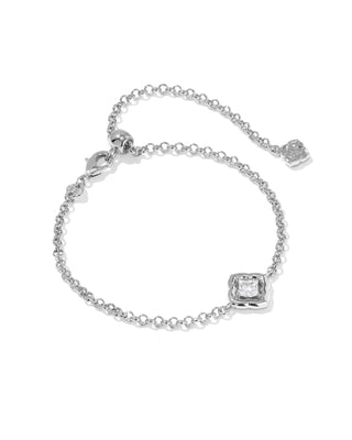A delicate silver chain bracelet with an adjustable lobster clasp, a small rose charm, and a square bezel-set clear gemstone accent