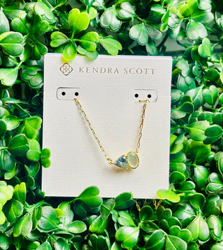 Tatum Gold Short Pendant Necklace featuring Elisa shape and trillion-cut March birthstone-inspired stone (light blue mix stone) on delicate gold chain.