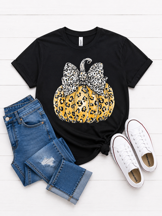 Printed on a black tee 
Front pattern tee 
Orange pumpkin with leopard detail 
with a leopard bow on the stem of the pumpkin