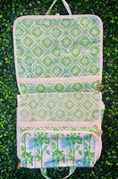 Stay organized and chic on your next getaway with the Lilly Pulitzer Swayin’ in the Breeze Hanging Toiletry Bag. Inspired by coastal breezes, this bag features a durable coated canvas exterior that’s easy to clean, making it perfect for beach trips, weekend retreats, or everyday travel.

Inside, a thoughtfully designed layout includes two interior PVC slip pockets, one mesh zip pocket, and a spacious main compartment with two additional mesh pockets, keeping all your essentials perfectly organized.
