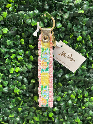 • Brand: Lilly Pulitzer
• Print: Lilly Garden Home
• Strap keychain bracelet design
• Hands-free convenience
• Ruffle detail
• Gold metal hardware
• Lightweight and easy to wear