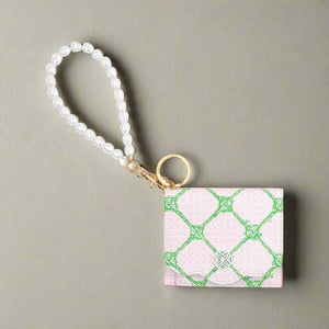 Lilly Pulitzer Butterfly Trellis snap card case with a scalloped envelope opening, card slots, a cash pocket, gold hardware, and a pearl wrist strap.