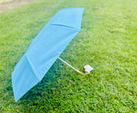 Let every rainy day feel like a walk by the shore with our travel umbrella, designed to bring coastal charm wherever the weather takes you. The sleek hydrangea blue canopy offers classic elegance, while the inside reveals our signature Swayin’ in the Breeze pattern. A bamboo-textured hook handle adds a natural, beachy touch, blending beauty and function in every detail. Whether protecting yourself from the sun or showers, this umbrella will help you do it in style.

