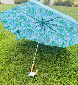 Let every rainy day feel like a walk by the shore with our travel umbrella, designed to bring coastal charm wherever the weather takes you. The sleek hydrangea blue canopy offers classic elegance, while the inside reveals our signature Swayin’ in the Breeze pattern. A bamboo-textured hook handle adds a natural, beachy touch, blending beauty and function in every detail. Whether protecting yourself from the sun or showers, this umbrella will help you do it in style.
