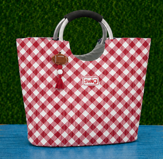 Fit &amp; Details | Spacious tote silhouette with a structured base
Handles | Sleek silver ring handles with a cushioned grip for comfortable carrying
Exterior | Durable, wipe-clean fabric in a classic crimson gingham print
Accents | Coordinating crimson tassel and football charm zipper pull
Branding | Signature Swig patch on front