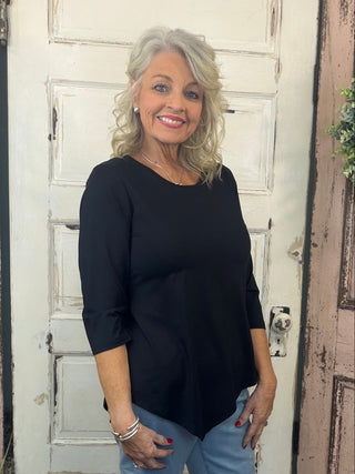 Step up your wardrobe with this Asymmetrical Black Top, a perfect blend of style and comfort. Crafted from a stretch knit blend (92% Nylon, 8% Spandex), it features a scoop neckline, 3/4 sleeves, and an asymmetrical hemline for a modern, flattering silhouette. With UPF 50 sun protection and pre-shrunk fabric, it’s as practical as it is chic.