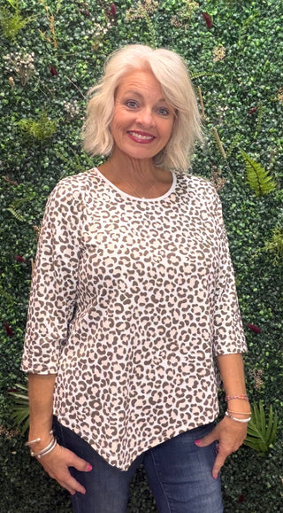 a beige and brown leopard print top with 3/4 sleeves. asymmetrical hem bottom