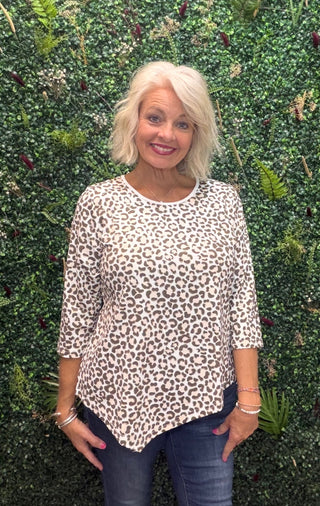 a beige and brown leopard print top with 3/4 sleeves. asymmetrical hem bottom