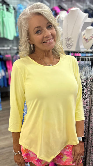 The Lulu-B Asymmetrical Top in Light Yellow is crafted from a soft, stretchy 92% Nylon / 8% Spandex blend in a soft, warm yellow hue — a flattering scoop neckline, 3/4 sleeves, and a chic asymmetrical hemline give it a modern, fashion-forward silhouette that brings a bright, happy energy to any warm-weather look. UPF 50 protection and pre-shrunk construction make it as practical as it is pretty.