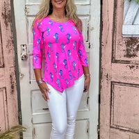Lulu-B Asymmetrical Top in Seahorse Hot Pink with UPF 50 fabric, scoop neckline, 3/4 sleeves, and a stylish asymmetrical hemline. Comfortable & pre-shrunk.