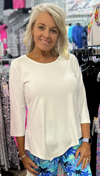  The Lulu-B Asymmetrical Top in White is crafted from a soft, stretchy 92% Nylon / 8% Spandex blend — a flattering scoop neckline, 3/4 sleeves, and a chic asymmetrical hemline give it a modern, fashion-forward silhouette that pairs beautifully with every color, print, and bottom in your wardrobe. UPF 50 protection and pre-shrunk construction make it as practical as it is polished.