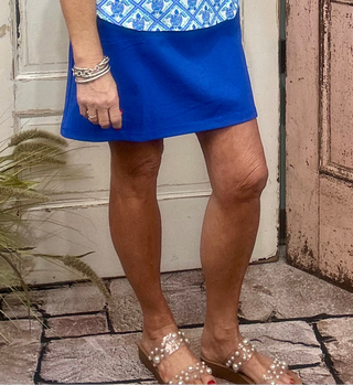 The Lulu-B Bangladine Skort is the perfect blend of sporty comfort and polished style. Crafted from Lulu-B’s signature bangladine fabric, this skort offers a smooth, structured feel with just the right amount of stretch. Designed with built-in shorts for confident coverage and a flattering silhouette, it’s ideal for travel, everyday wear, or staying active while still looking put together. Easy to style and effortless to wear, this skort is a warm-weather essential.