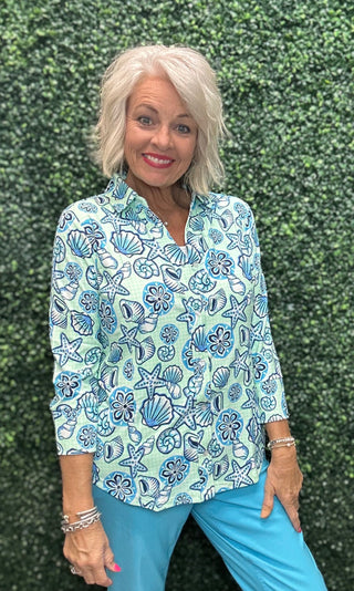 Fabric | 92% Nylon / 8% Spandex, crinkle texture
UPF | 50+ sun protection
Silhouette | Long sleeve button blouse, relaxed fit
Collar | Pointed foldover
Shoulders | Drop shoulder
Hemline | Curved
Detail | Center seam; mint gingham with allover seashell print (GISB)
Length | 28" center back