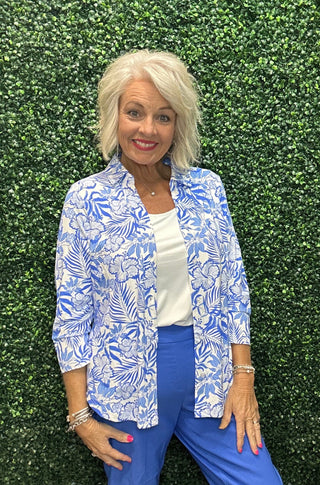 Fabric | 92% Nylon / 8% Spandex, crinkle texture
UPF | 50+ sun protection
Silhouette | Long sleeve button blouse, relaxed fit
Collar | Pointed foldover
Shoulders | Drop shoulder
Hemline | Curved
Detail | Center seam; blue and white tropical hibiscus and palm leaf print (SBPR)
Length | 28" center back
