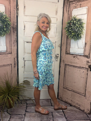 Feminine, flattering, and sun-safe! This best-selling sleeveless dress features charming ruffles on the front and back, a scoop neckline, and a straight hemline. Crafted from a soft 92% Nylon / 8% Spandex blend, it offers a comfortable, stretchy fit that flatters all shapes and sizes. With UPF50 sun protection and a 30.5" length, it’s perfect for sunny days, travel, or everyday wear. Pre-shrunk for a lasting fit—just machine wash and hang dry for easy care!