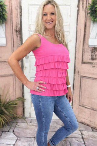 The Lulu-B Cha Cha Tank in Bright Hot Pink is crafted from soft, stretchy fabric with front and back ruffles that bring a playful, feminine energy to any outfit — that vibrant pink hue makes it the kind of piece that instantly elevates your warm-weather wardrobe.