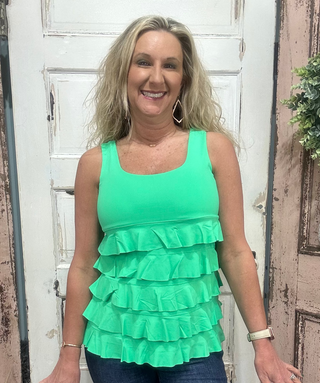 Flirty, fun & sun-safe! The Cha Cha Tank features ruffles, UPF50 protection, & a flattering fit—perfect for sunny days, travel, or everyday wear.

Features ruffle details and a Kelly Green color tank