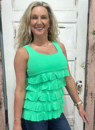 Flirty, fun & sun-safe! The Cha Cha Tank features ruffles, UPF50 protection, & a flattering fit—perfect for sunny days, travel, or everyday wear.

Features ruffle details and a Kelly Green color tank