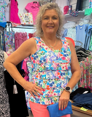 Flirty, feminine, and made for sunny adventures. The Lulu-B Cha Cha Tank in MCDR features a beautiful tropical floral and water scene with charming dragonfly details — front and back ruffles, a scoop neckline, and a straight hemline give it a playful, resort-inspired silhouette that pairs effortlessly with any bottom for an effortless warm-weather look. Soft, stretchy fabric with UPF 50 protection and a 30.5" length 