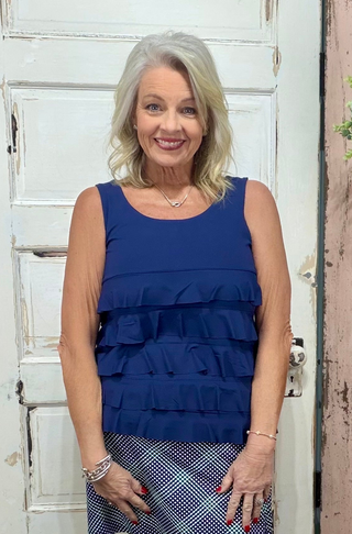 Turn heads with the flirty and fun Cha Cha Tank! Designed with soft, stretchy fabric and UPF50 protection, this feminine favorite features front and back ruffles, a scoop neckline, and a straight hemline at the waist. At 30.5" long, it pairs perfectly with any bottoms for effortless summer style. Machine washable and hang dry for easy care—add a little cha cha to your wardrobe today!