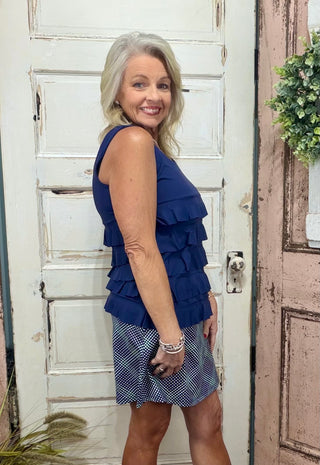 Turn heads with the flirty and fun Cha Cha Tank! Designed with soft, stretchy fabric and UPF50 protection, this feminine favorite features front and back ruffles, a scoop neckline, and a straight hemline at the waist. At 30.5" long, it pairs perfectly with any bottoms for effortless summer style. Machine washable and hang dry for easy care—add a little cha cha to your wardrobe today!