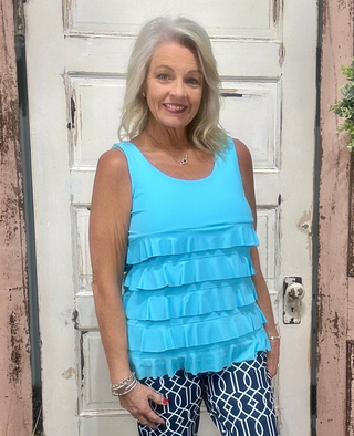 Turn heads with the flirty and fun Cha Cha Tank! Designed with soft, stretchy fabric and UPF50 protection, this feminine favorite features front and back ruffles, a scoop neckline, and a straight hemline at the waist. At 30.5" long, it pairs perfectly with any bottoms for effortless summer style. Machine washable and hang dry for easy care—add a little cha cha to your wardrobe today!