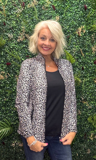 Print | Black leopard print
Collar | Mock neck style
Zipper | Two-way full-length zipper
Sleeves | Long sleeves
Pockets | Front pockets
Details | Contrast stitching at seams, slight high-low hemline
Length | 25" center back
Fabric | 92% Nylon / 8% Spandex — signature cooling blend