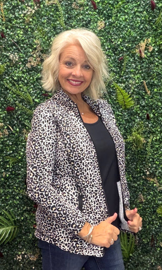 Print | Black leopard print
Collar | Mock neck style
Zipper | Two-way full-length zipper
Sleeves | Long sleeves
Pockets | Front pockets
Details | Contrast stitching at seams, slight high-low hemline
Length | 25" center back
Fabric | 92% Nylon / 8% Spandex — signature cooling blend