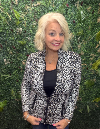 Print | Black leopard print
Collar | Mock neck style
Zipper | Two-way full-length zipper
Sleeves | Long sleeves
Pockets | Front pockets
Details | Contrast stitching at seams, slight high-low hemline
Length | 25" center back
Fabric | 92% Nylon / 8% Spandex — signature cooling blend
