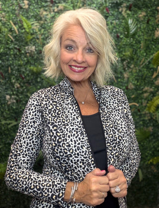 Print | Black leopard print
Collar | Mock neck style
Zipper | Two-way full-length zipper
Sleeves | Long sleeves
Pockets | Front pockets
Details | Contrast stitching at seams, slight high-low hemline
Length | 25" center back
Fabric | 92% Nylon / 8% Spandex — signature cooling blend