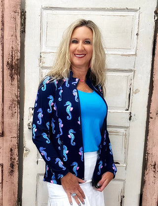 The Lulu-B Full Zip Jacket in Navy Seahorse features a whimsical seahorse print on a classic navy base — a mock neck collar, two-way zipper, and contrast stitching at the seams give it a refined, athletic-inspired finish that works just as well over a matching set as it does thrown over jeans for a casual day out.