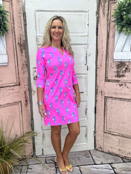 Notched Travel Dress in Hot Pink Seahorse, featuring lightweight SPF fabric and 3/4 sleeves for stylish sun protection. Perfect for travel and adventure.