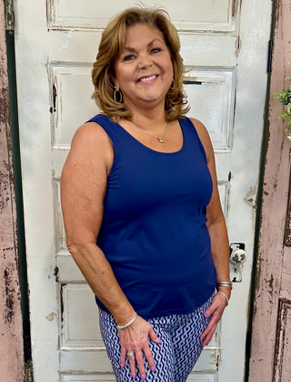 Sleeveless tank top made from soft stretchy nylon spandex fabric, classic tank neckline, straight hemline, 24-inch back length, pre-shrunk and machine washable for everyday comfort and layering.