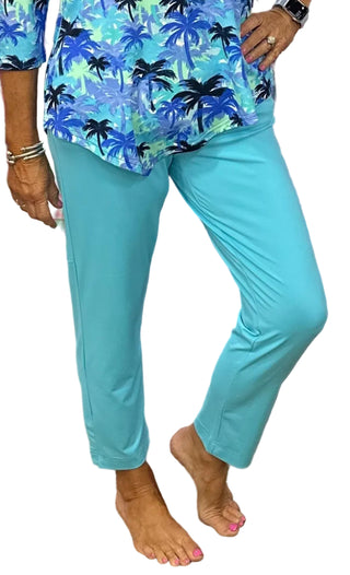 The Lulu-B Secret Pocket Capri in Turquoise is crafted from breathable, cooling fabric in a vivid, eye-catching turquoise hue — UPF 50 protection, a flattering 25" inseam, and a hidden pocket detail make these as practical as they are stylish, whether you're walking, traveling, or simply soaking up the sun.