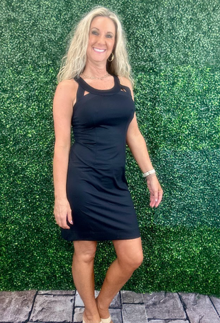 Sleek, flattering, and made for sunny days, this Slip-Over Cutout Dress blends modern style with performance comfort. Designed with a rounded neckline and front and back cutout details, it offers just the right touch of edge while maintaining a streamlined silhouette. Bust darts and front/back seams enhance shape and fit, creating a confident, curve-flattering look. Crafted from a smooth, stretchy fabric with UPF 50 sun protection, this dress is perfect for warm-weather outings, vacations, or active days wh