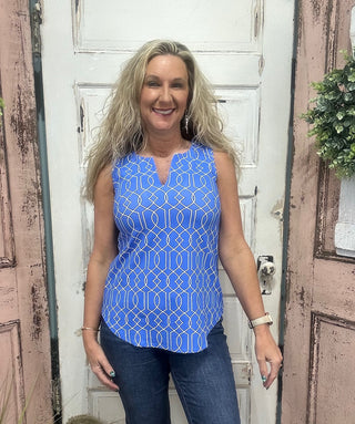 The Sleeveless Key Hole Top is the perfect blend of style, comfort, and function. Crafted from a lightweight, stretchy nylon blend, this top features a flattering V-neckline with a chic keyhole detail and a straight hem for an easy, polished silhouette. Pre-shrunk for a consistent fit and designed with UPF50 sun protection, it’s ideal for sunny days, travel, or everyday wear—keeping you cool while looking effortlessly put together.

Pattern Features: Blue/Black/White geometric pattern