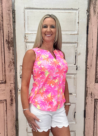 The Sleeveless Keyhole Top in the Palm Tree print features a bold pink, orange, and yellow palm tree design with a V-style neckline and delicate keyhole detail — that warm, sun-drenched print brings an instant resort energy to any warm-weather outfit, whether you're poolside or out for brunch.