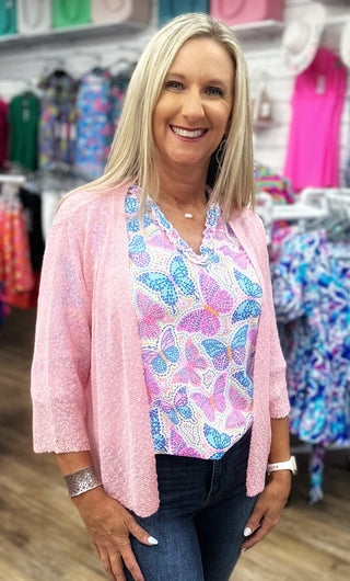 The Lulu-B Textured Cardigan in Soft Pink features a beautiful woven pattern with a richly textured fabric in a gentle, blush-toned pink hue — super lightweight construction provides breezy arm coverage without adding warmth, making it the perfect layer for warm-weather days when you want a soft, pretty finishing touch without the heat.