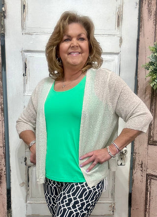 This cardigan features a beautiful weave pattern with textured fabric, adding a touch of summer to your wardrobe. The intricate design creates a unique and subtle look that you'll love.