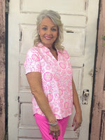 Elevate your wardrobe with the Lulu B Short Sleeve V-Neck Top with Collar, featuring butter-soft, wrinkle-free fabric that offers both luxury and practicality. This top is designed with UPF 50+ sun protection, making it a must-have for sunny days and travel. The added collar gives it a polished, sophisticated look, while the lightweight, breathable fabric ensures all-day comfort. Ideal for both casual outings and more dressed-up moments, this top packs neatly without wrinkles, so you can always look put tog
