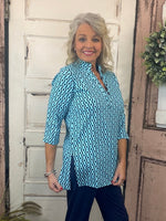 Jet set in ultimate style in the Women's V-Neck Travel Tunic Top from Lulu-B! This beautifully sleek shirt is made from a wonderfully smoothing nylon blend that will skim your curves just right, plus the fabric has UPF 50+ sun protection to keep your mind at ease on even the hottest days. A stunning v-neckline doesn't compromise on cuteness when your priority is comfort, so you'll be looking and feeling great in this tunic-length top. The vibrant colors and patterns of this adorable quarter-sleeve top add p
