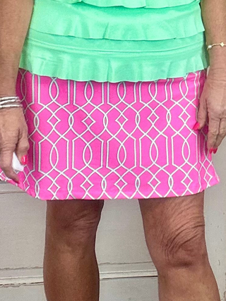 UPF50+ zip skort with pull-on waistband, lightweight A-line fit, sewn-in shorts for coverage, zip side slit, back zip pocket, front pocket, 17-inch skirt length, machine washable performance fabric.