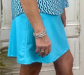 Zip Skort, delivering a lightweight fit with superior UPF50+ sun protection. The pull-on skort features an optional zip side-slip and boasts additional utility with a zip back pocket and small front pocket. Sewn-in shorts also provide extra coverage, and the fabric is pre-shrunk and machine washable for long-lasting wear.

2-inch pull on waistband

A-line styling

UPF50 sun protection fabric

Skirt length: 17 inches.
Machine wash and hang dry