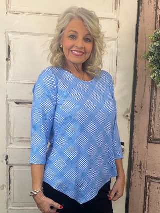 Stay stylish and protected in the Lulu-B Asymmetrical Top, crafted from a stretchy nylon-spandex blend. This flattering scoop-neck top features 3/4 sleeves and a chic asymmetrical hemline. With built-in UPF 50 sun protection and pre-shrunk fabric, it's perfect for sunny days, travel, or everyday wear—easy, polished, and effortlessly comfortable.