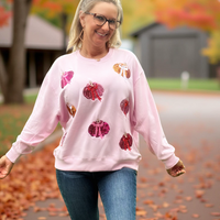 Indulge in cozy autumn vibes with the&nbsp;Sarah Sweatshirt – Pumpkin. Made from an ultra-soft blend of 94% buttery polyester and 6% spandex, this sweatshirt offers the perfect balance of comfort and stretch. Sparkling sequin pumpkins and detailed flat embroidery add a festive, eye-catching touch, making it a stylish standout for fall. Whether you're headed to the pumpkin patch or lounging at home, this sweatshirt brings warmth, charm, and seasonal flair to your wardrobe.