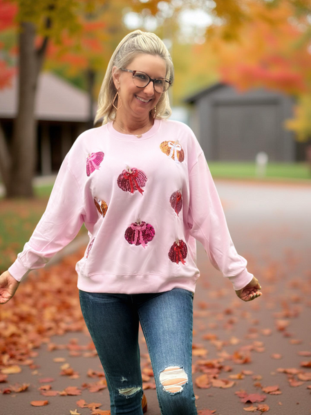 Indulge in cozy autumn vibes with the Sarah Sweatshirt – Pumpkin. Made from an ultra-soft blend of 94% buttery polyester and 6% spandex, this sweatshirt offers the perfect balance of comfort and stretch. Sparkling sequin pumpkins and detailed flat embroidery add a festive, eye-catching touch, making it a stylish standout for fall. Whether you're headed to the pumpkin patch or lounging at home, this sweatshirt brings warmth, charm, and seasonal flair to your wardrobe.