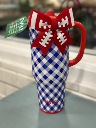 A red and white gingham patterned insulated tumbler with a red handle, decorated with a red bow featuring white football laces